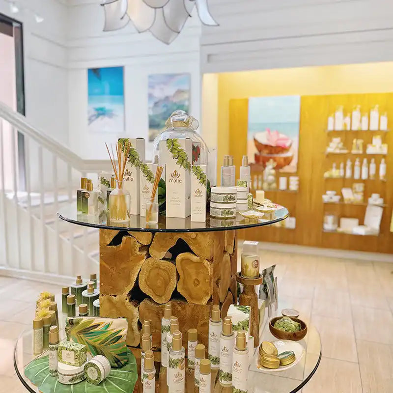 A circular tiered display stand showcasing beauty products and bottles.